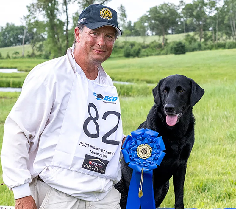 Jack Gwaltney III and 2025 National Amateur Retriever Champion, Tux, a male black Labrador. 