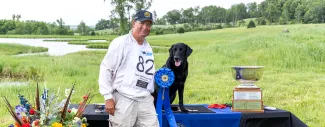 Jack Gwaltney III posing with 2025 National Amateur Retriever Championship winner Tux. 