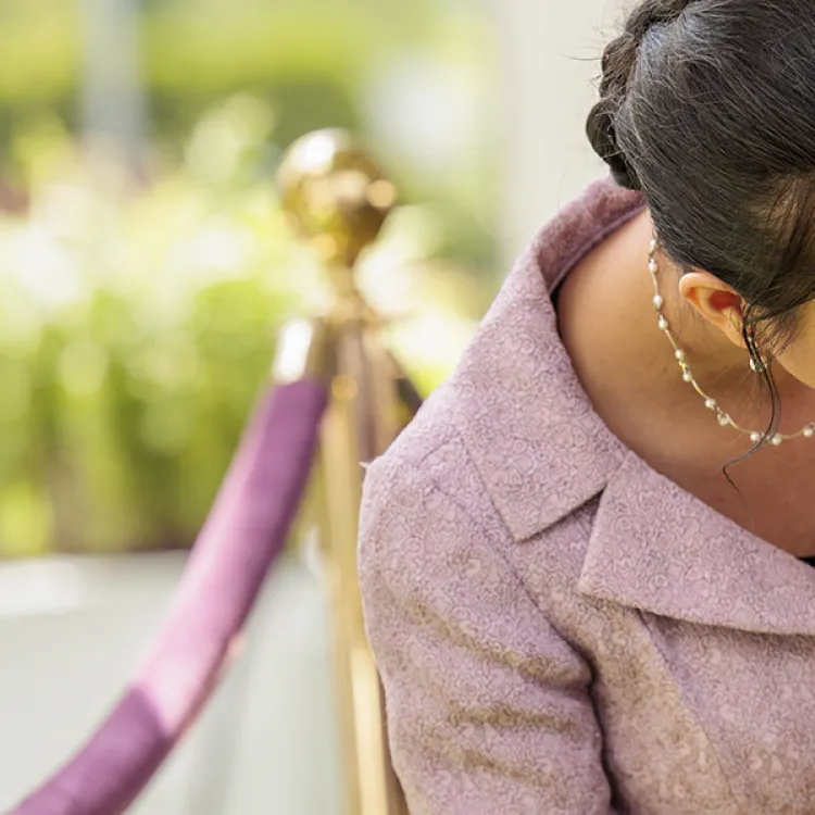 A human bending down and kissing their dog’s head.
